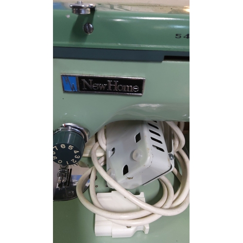 441 - Vintage New Home sewing machine in green with original case and accessories. Comes with foot pedal a... 