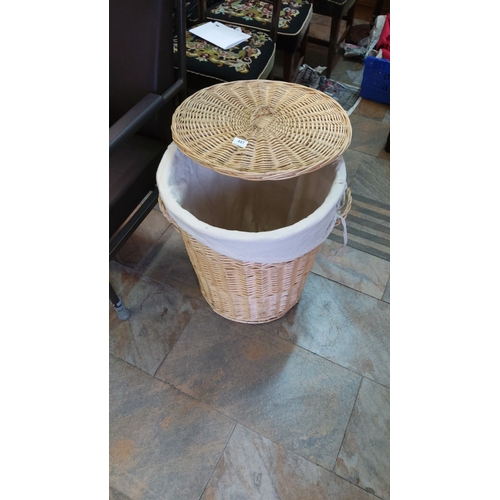 447 - Wicker laundry basket with removable lid and fabric lining. It has side handles.