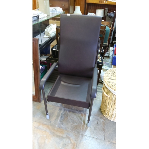 448 - Black vinyl upholstered high-back adjustable height chair with sturdy metal frame and armrests. Comf... 