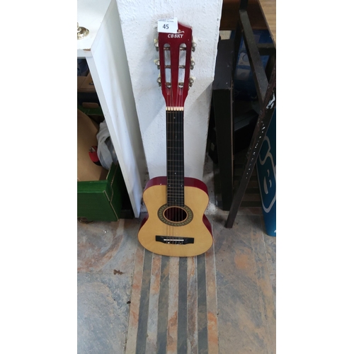 45 - CB SKY classical acoustic guitar with a natural wood body and red headstock.