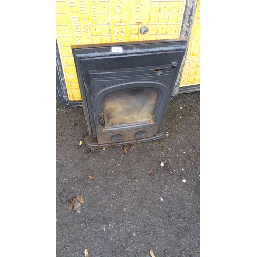 456 - Cast iron stove inset with arched glass panel and adjustable vent controls.(needs rope around door)