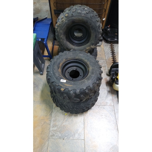 468 - Set of four heavy-duty off-road tires with steel rims. Rugged tread design for superior traction.