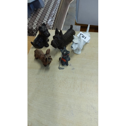 501 - Collection of five vintage dog figurines made of ceramic, metal, and wood. Features Scottie and terr... 