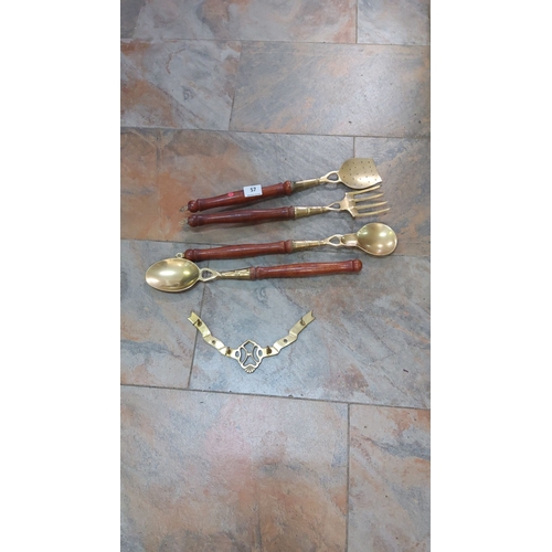 57 - Vintage brass and wood wall-mounted kitchen utensil set, including ladle, fork, strainer, serving sp... 