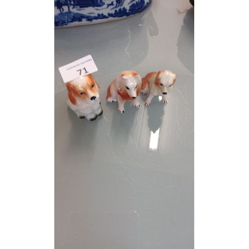 71 - Set of three vintage porcelain dog figurines, hand-painted with charming detail and featuring glossy... 