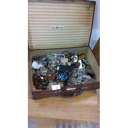 76 - Vintage Turtle Brand suitcase filled with an assorted collection of costume jewelry, including neckl... 