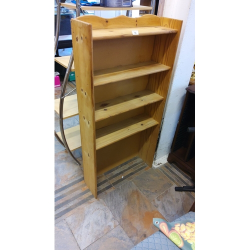 98 - Solid pine wall-mounted bookshelf with four fixed shelves and a decorative scalloped top.