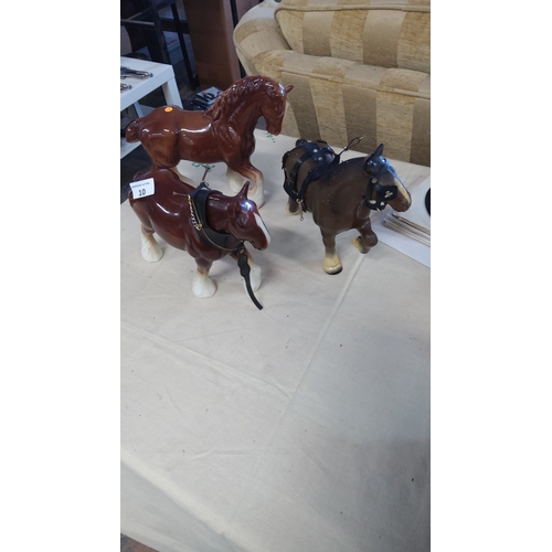 10 - Three vintage ceramic and resin draft horse figurines, two with leather harness details. Finely craf... 