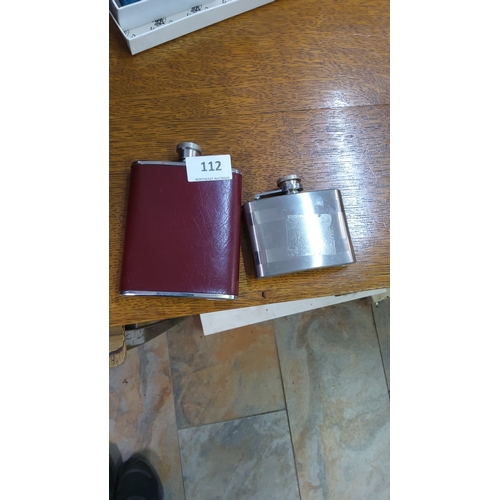 112 - Pair of stainless steel hip flasks, one with a burgundy leather wrap, the other with a brushed metal... 