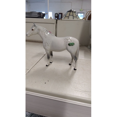 129 - Beswick porcelain horse figurine, hand-painted in a dapple grey finish. From the renowned English po... 