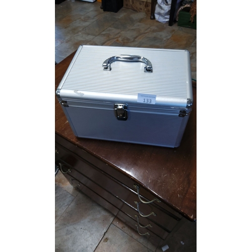 133 - Silver-tone aluminum storage case with reinforced corners, secure latch, and sturdy handle. Interior... 