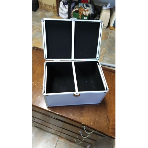 133 - Silver-tone aluminum storage case with reinforced corners, secure latch, and sturdy handle. Interior... 