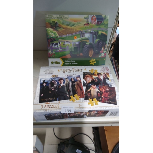 139 - Two new boxed puzzle sets, including a John Deere-themed 70-piece puzzle and a Harry Potter collecti... 