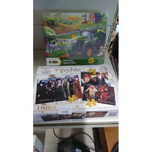 139 - Two new boxed puzzle sets, including a John Deere-themed 70-piece puzzle and a Harry Potter collecti... 