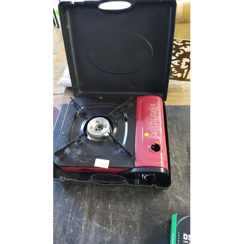 147 - Portable single-burner gas stove in a protective carrying case, featuring a compact design and easy ... 