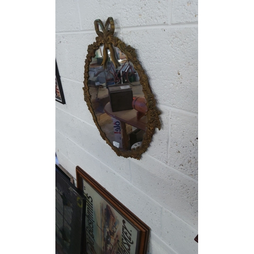 152 - Vintage gilt-framed oval mirror with ribbon crest, featuring a Rococo-style floral design.