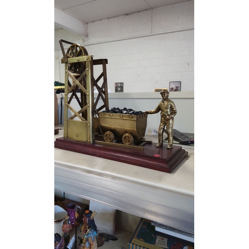 2 - Brass coal miner sculpture with cart and winch, mounted on a wooden base.