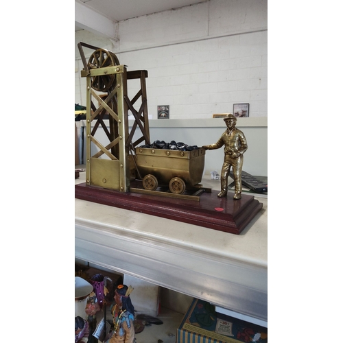 2 - Brass coal miner sculpture with cart and winch, mounted on a wooden base.