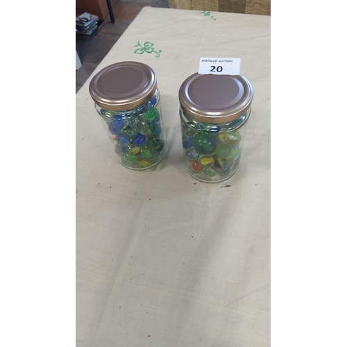 20 - Two glass jars filled with vintage glass marbles in assorted colors.