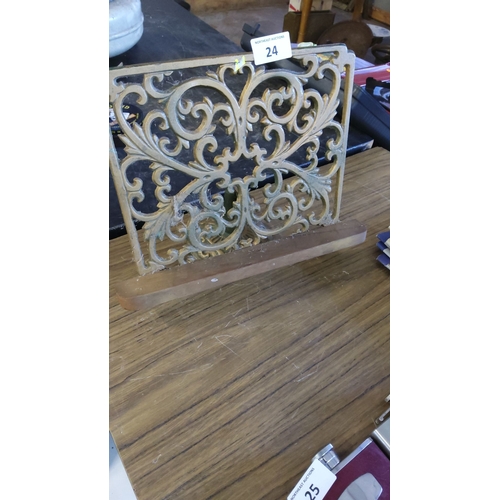 24 - Cast iron and wood book/menu holder with intricate scrollwork design.