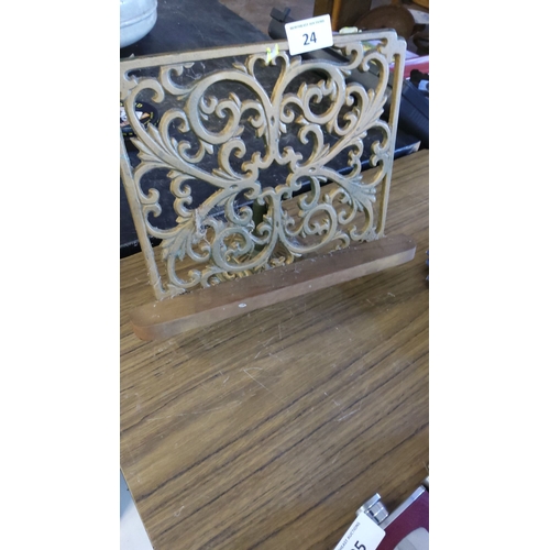 24 - Cast iron and wood book/menu holder with intricate scrollwork design.