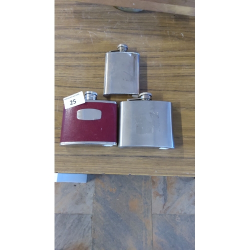 25 - Set of three stainless steel hip flasks, one with a red leatherette cover and engraved plaque.