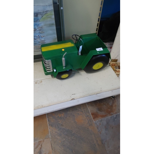 27 - Vintage green metal toy tractor planter with yellow detailing. Features oversized wheels.