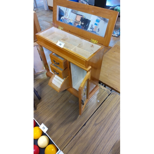 34 - Wooden jewelry cabinet with mirrored top, floral-accented doors, and multiple storage compartments. ... 