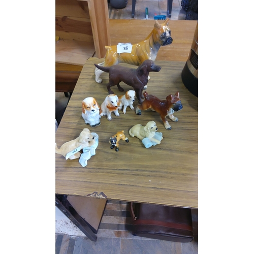 36 - Collection of vintage porcelain and ceramic dog figurines, various breeds and sizes, detailed with g... 