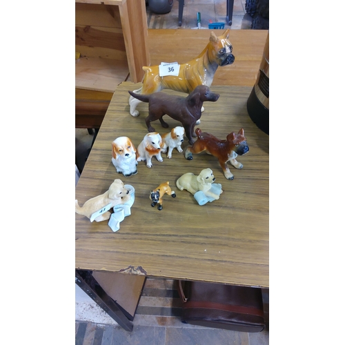 36 - Collection of vintage porcelain and ceramic dog figurines, various breeds and sizes, detailed with g... 