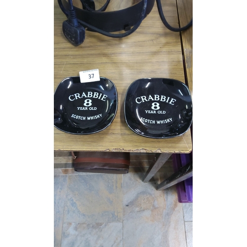 37 - Pair of vintage Crabbie 8-Year-Old Scotch Whisky ceramic ashtrays. Glossy black with bold white lett... 