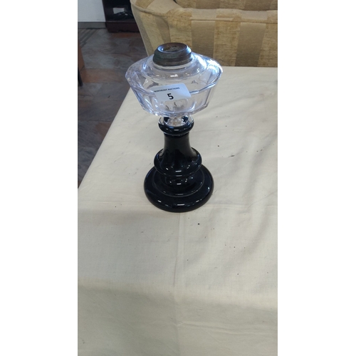 5 - Antique glass oil lamp with a faceted clear glass font and a black glass pedestal base. Features a m... 