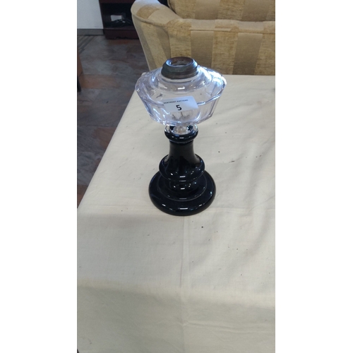 5 - Antique glass oil lamp with a faceted clear glass font and a black glass pedestal base. Features a m... 