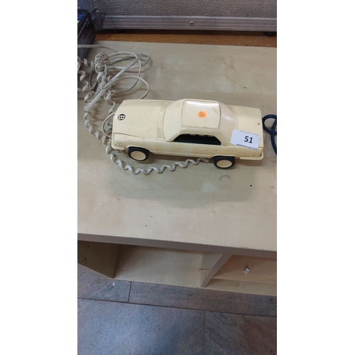 51 - Vintage car-shaped landline telephone from the 1980s. Cream-colored plastic body with rotary-style p... 