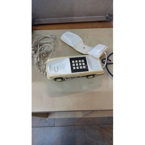 51 - Vintage car-shaped landline telephone from the 1980s. Cream-colored plastic body with rotary-style p... 