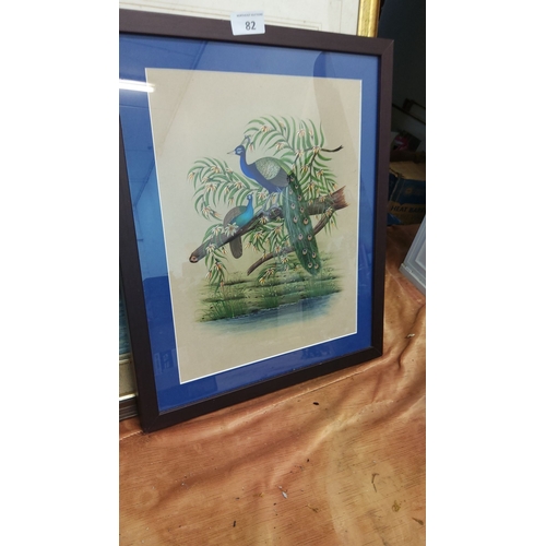 82 - Framed artwork depicts vibrant peacocks perched on a branch, detailed with rich colors. Set in a sim... 