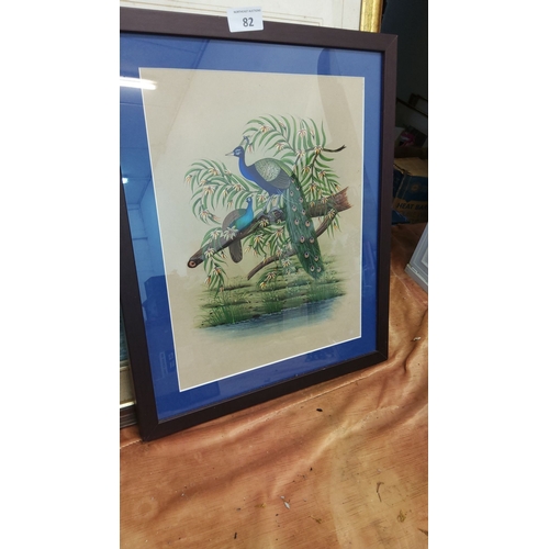 82 - Framed artwork depicts vibrant peacocks perched on a branch, detailed with rich colors. Set in a sim... 