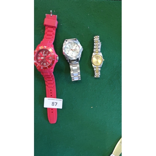 87 - Lot of three wristwatches, including a bold red BCN quartz watch, silver-tone chronograph-style watc... 