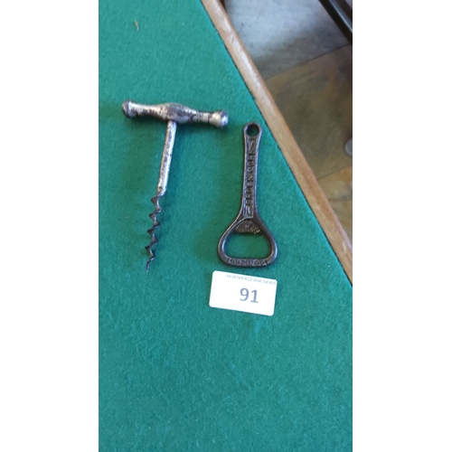 91 - Vintage metal corkscrew with T-handle and cast iron bottle opener, marked with patent number.