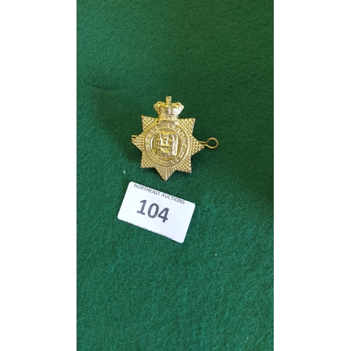 104 - Gilt brass eight-pointed star badge of the East Surrey Regiment, crowned castle motif within circlet... 