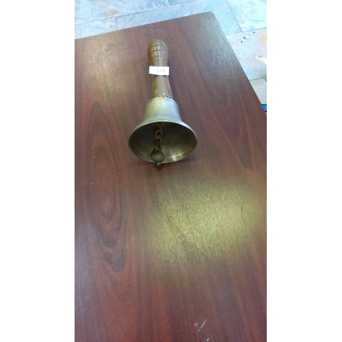 116 - Turned hardwood and cast brass hand bell, cylindrical handle with concentric rings above a flared be... 