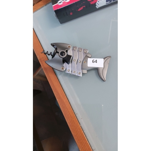 64 - Brushed metal novelty corkscrew and bottle opener styled as a skeletal fish, with hinged body plates... 