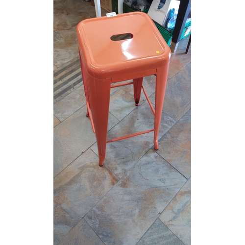 69 - Orange powder-coated metal industrial bar stool, square seat with oblong hand-grip aperture, splayed... 