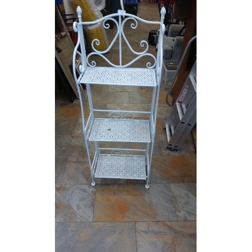 71 - White-painted wrought-iron three-tier étagère or plant stand, pierced lattice shelves beneath scroll... 