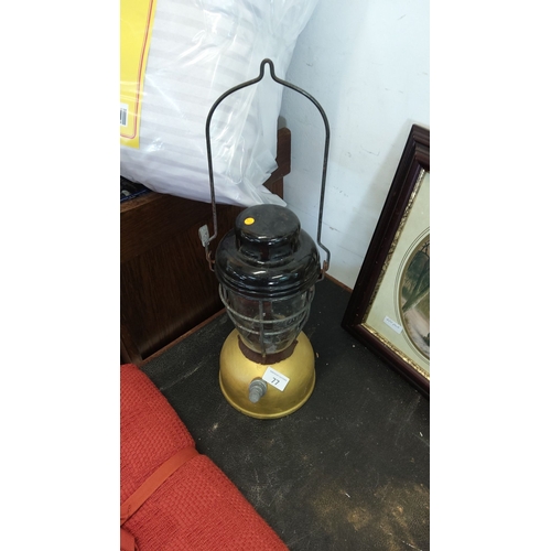 77 - Vintage industrial metal and glass lantern with protective wire cage, iron carrying handle and bell-... 