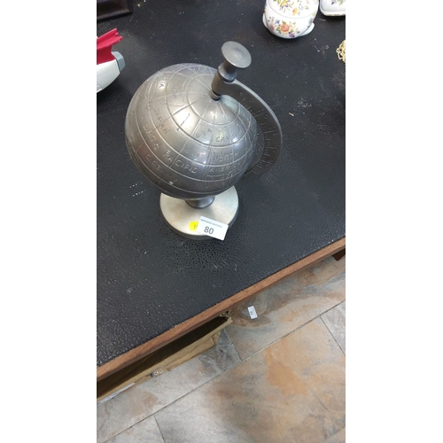 80 - Cast metal desktop terrestrial globe with engraved continental outlines and meridian arc, raised on ... 