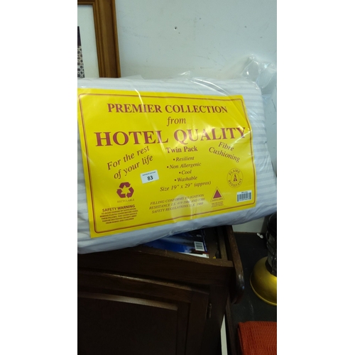 83 - Sealed twin-pack fibre-filled pillows, “Premier Collection from Hotel Quality,” striped cover, appro... 