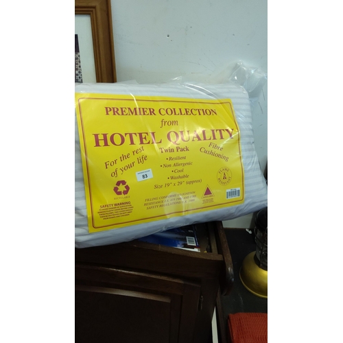 83 - Sealed twin-pack fibre-filled pillows, “Premier Collection from Hotel Quality,” striped cover, appro... 