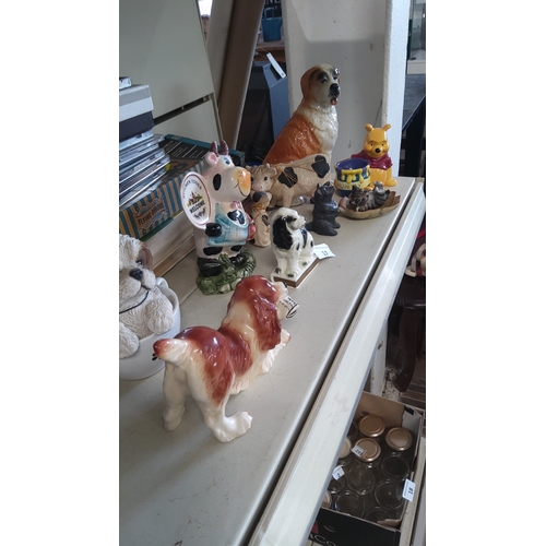 17 - Group of ten ceramic and resin animal figurines, including dogs, cows, cat and a Winnie-the-Pooh cha... 
