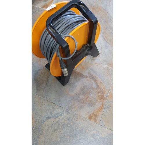 20 - Orange plastic portable cable reel housing long grey XLR audio lead, terminating in male XLR plug, m... 